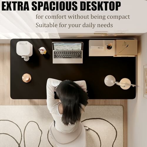 Top view of a person at a spacious desk with laptop and accessories.